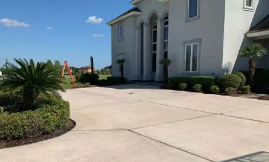 Clean residential driveway and exterior pressure washing area